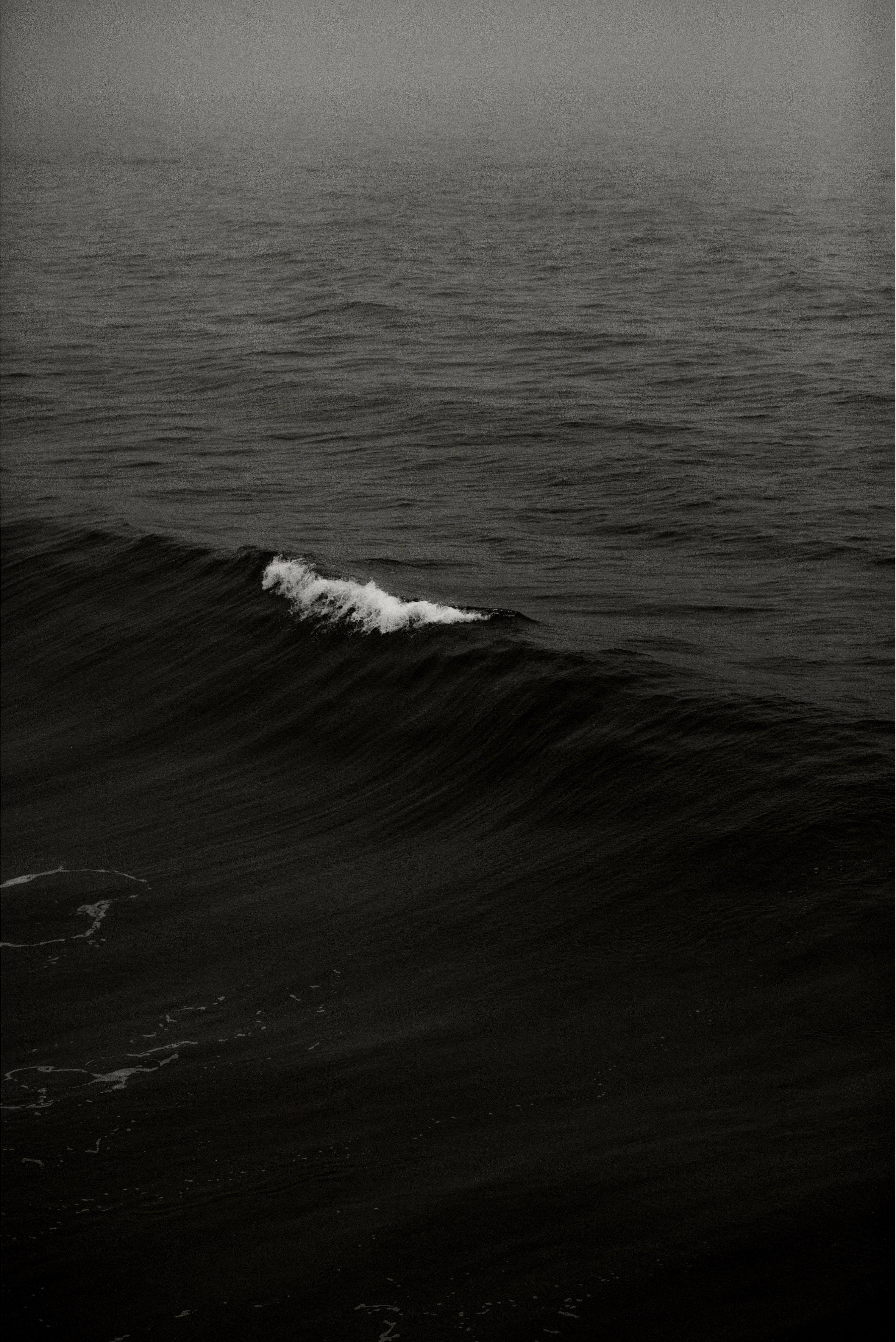 Macro shot of ocean waves resembling abstract monochrome patterns